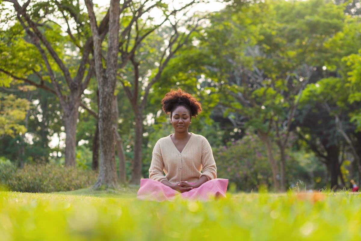 Woman meditating in nature — Theta brainwave state